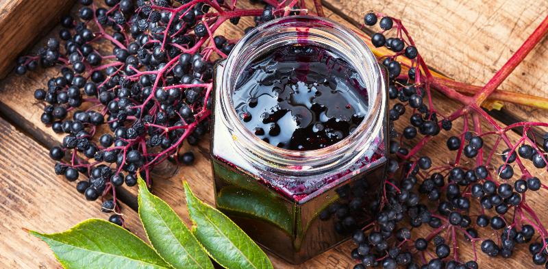 an open hexagonal jar full of jam